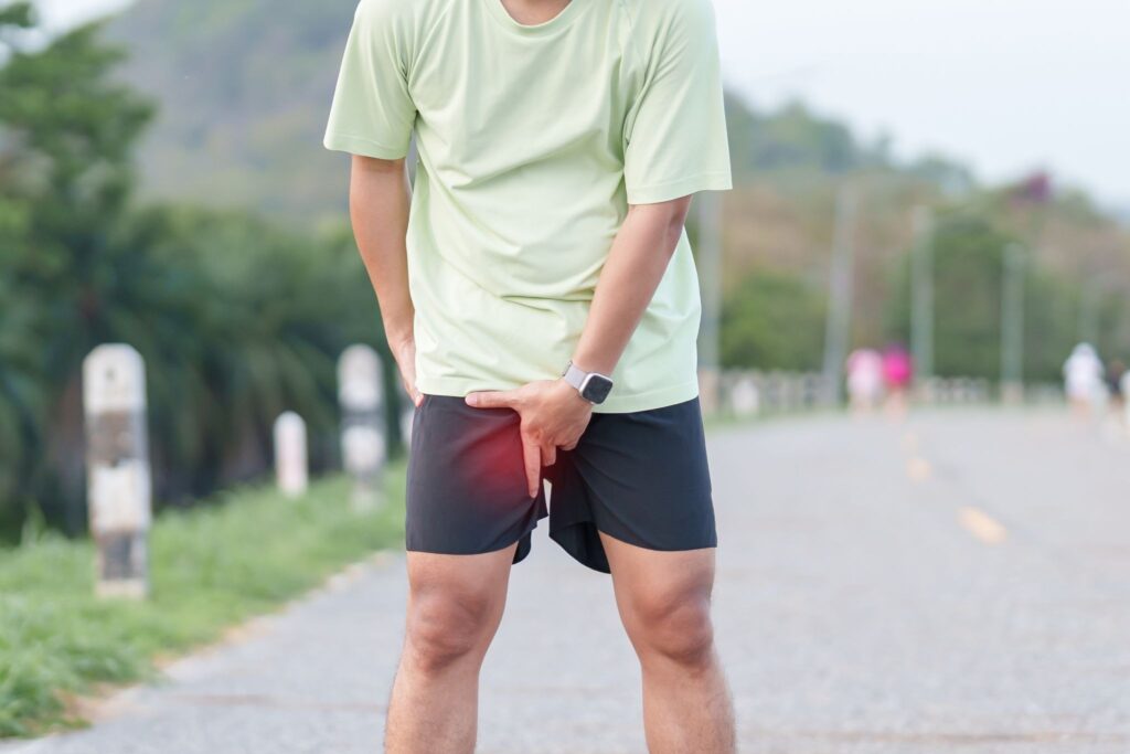 Person experiencing groin pain consistent with sportsman's groin after physical activity.
